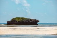 Green and Brown Island on Blue Sea Under Blue Sky