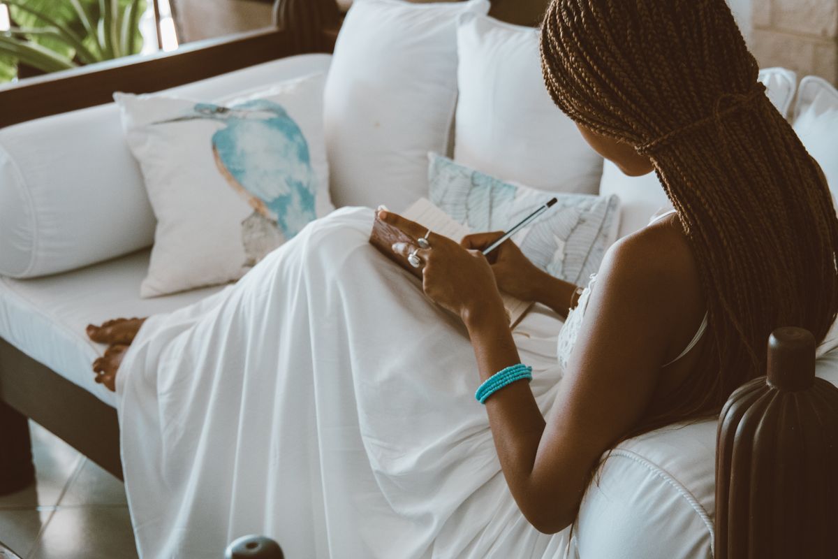 Woman journaling quietly at home as part of healing from emotional betrayal