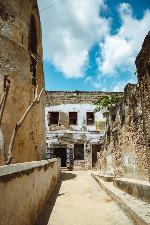 Narrow Alley Between Old Abandoned Stone Walls