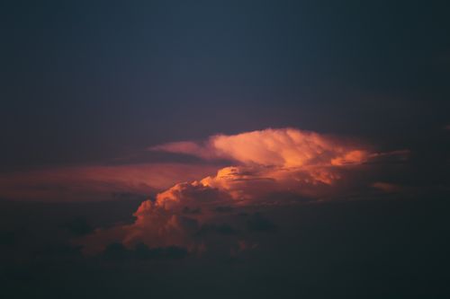 Free Vivid cloud formations illuminated by the setting sun during a dramatic sunset scene. Stock Photo
