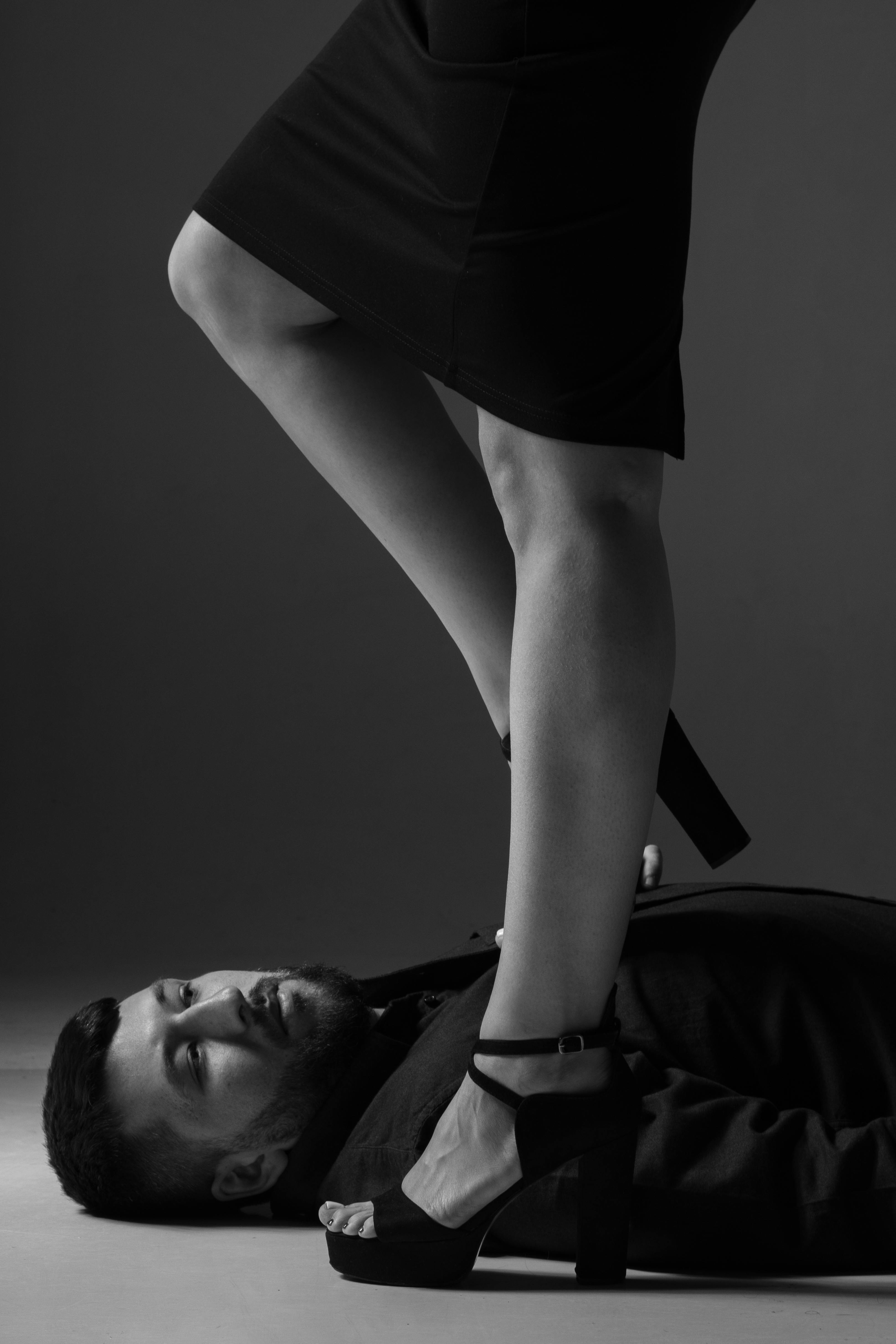 a man lying on the floor while looking at person s legs