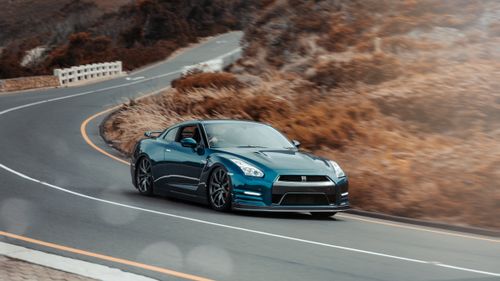 Free Thrilling drive with a blue sportscar navigating a curvy mountain road in scenic Rooi-Els, South Africa. Stock Photo