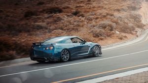 Blue Nissan GT-R on a road