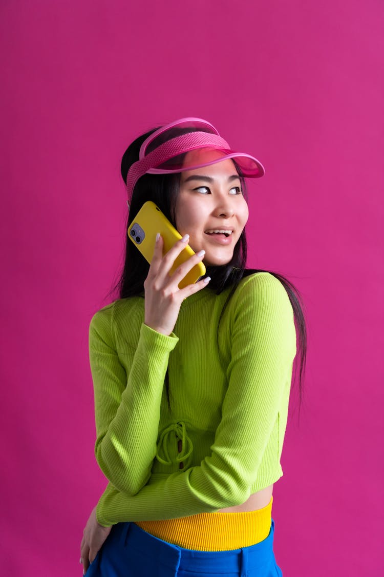 Young Woman In Colourful Outfit Talking On Mobile Phone