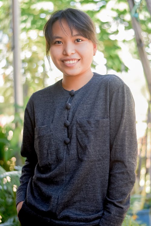 A Smiling Woman in Gray Sweater