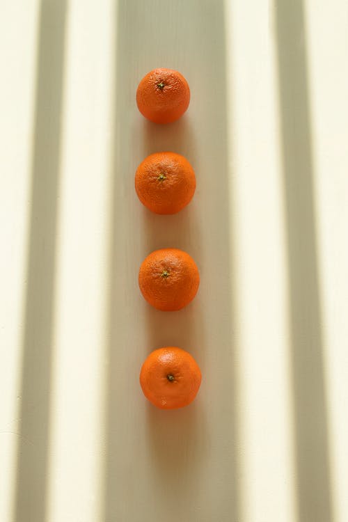 Orange Fruits on White Surface