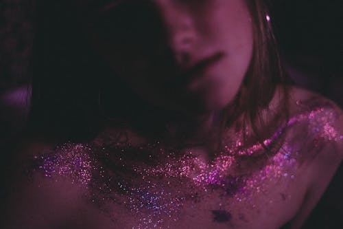 A Woman With Purple Glitters on Her Chest