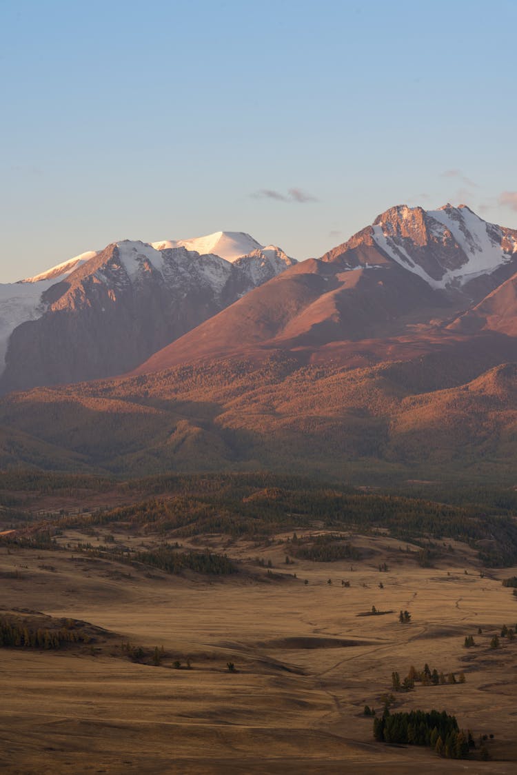 Brown And White Mountains Under Blue Sky