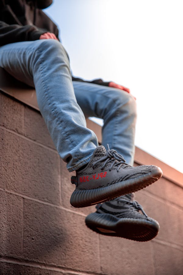 Person Wearing Adidas Yeezy Boost Shoes