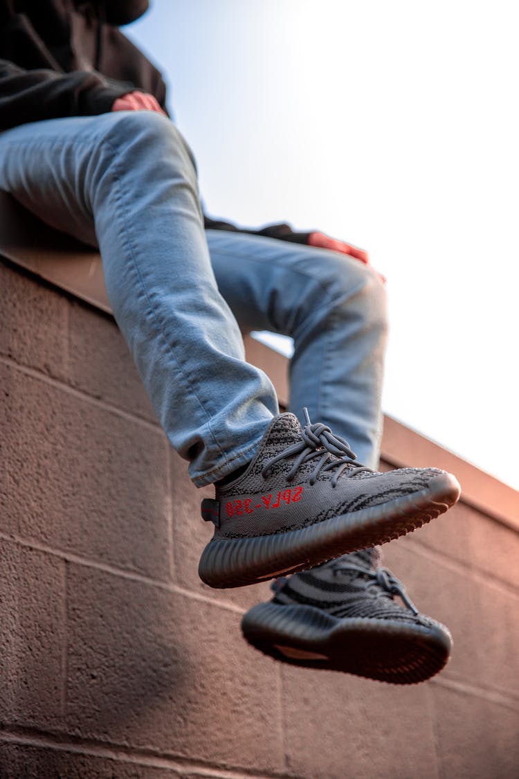 Person Wearing Adidas Yeezy Boost Shoes