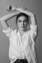 Monochrome portrait with raised arms — photo by Vitaly Gorbachev on Pexels