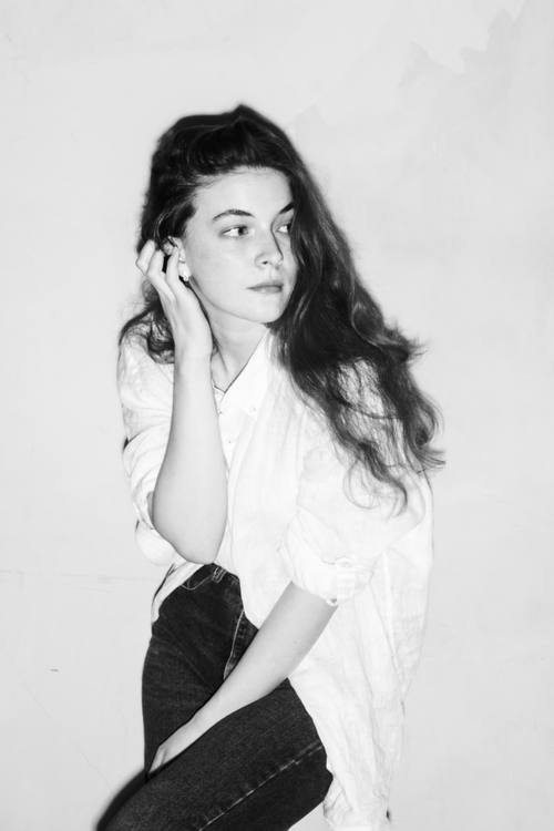 Free Stylish black and white portrait of a young woman in a thoughtful pose. Stock Photo