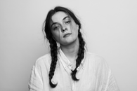 Woman in Braided Hair Wearing Button Up Shirt