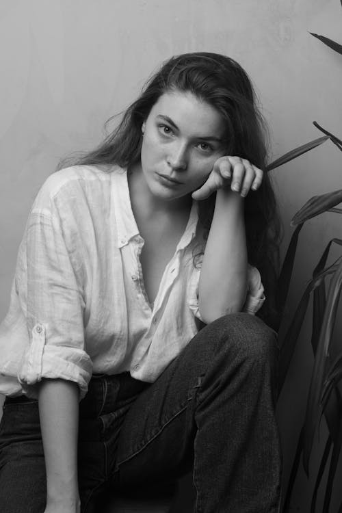 Black and White Portrait of Woman Sitting on Ground