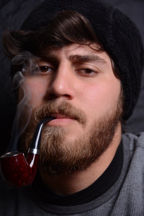 Free A Man in Black Knit Cap Smoking Stock Photo