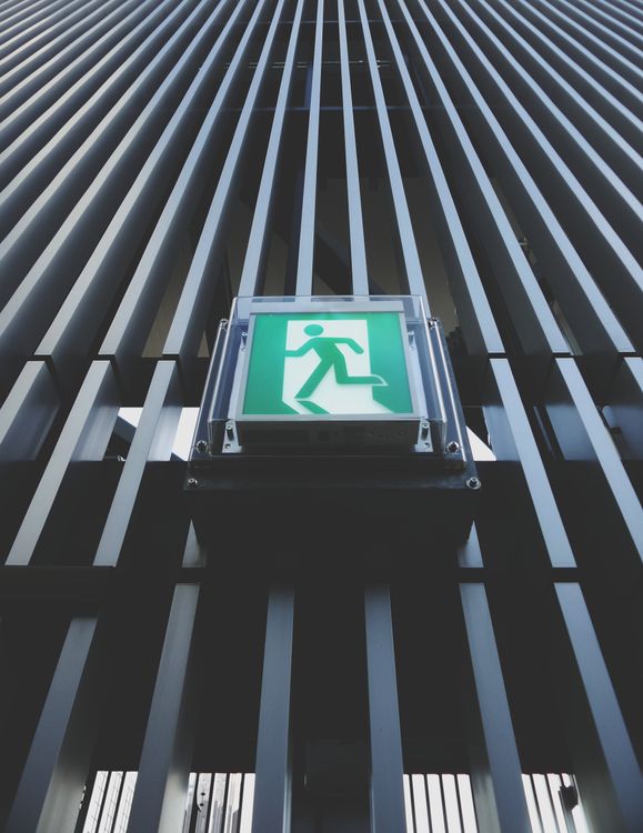 Exit Sign In Building Modern Building Facade with an Exit Sign · Free Stock Photo