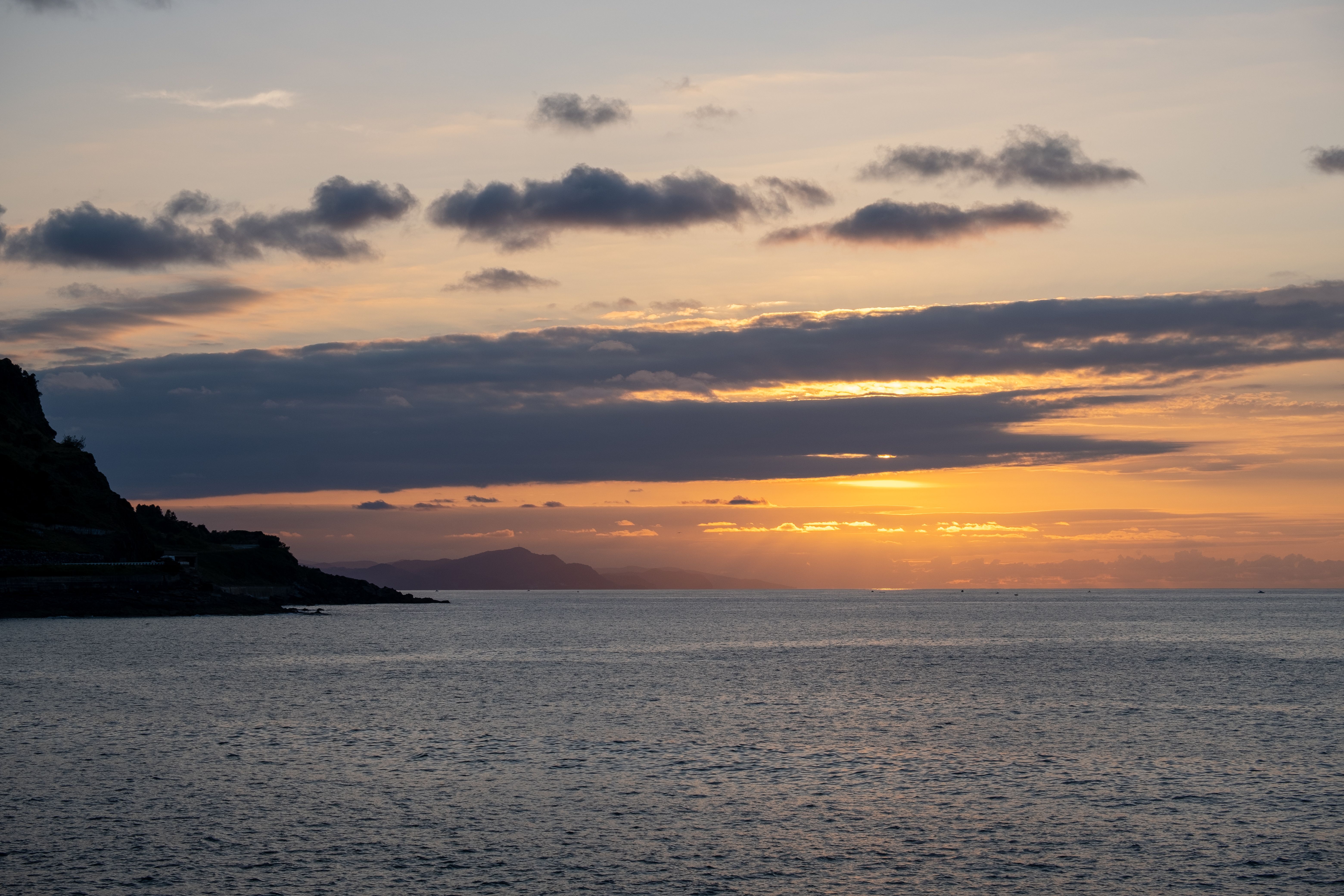 Silhouette of Mountain Beside Sea during Sunset · Free Stock Photo