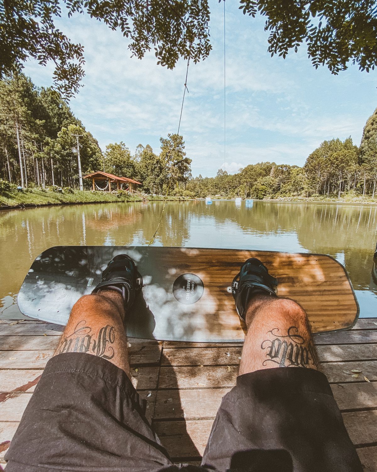 Point-of-view shot riding a board behind a boat on a lake