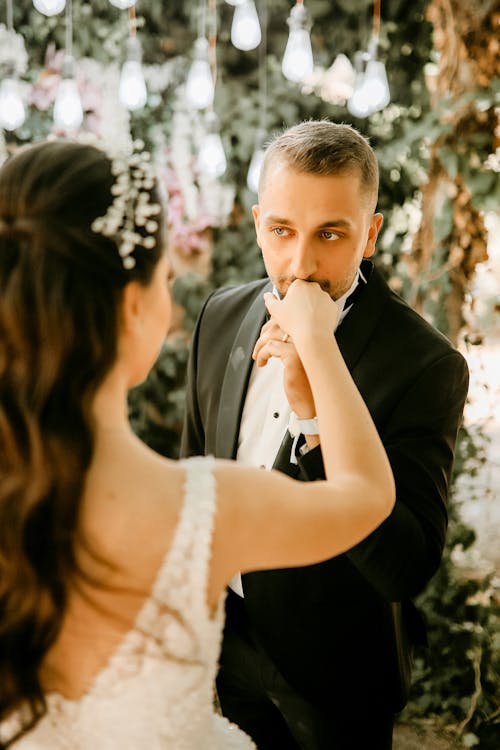 A Romantic Groom Kissing His Bride's Hand