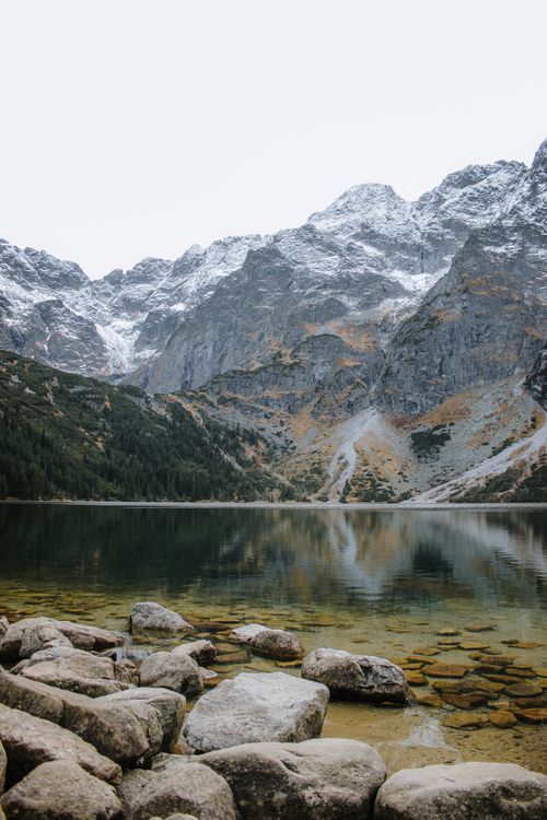 Free Breathtaking view of a serene mountain lake with rocky shore in Zakopane, Poland. Stock Photo