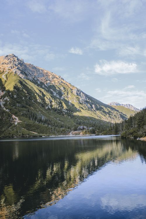 Free Scenic view of a tranquil mountain lake with reflections in Zakopane, Poland. Stock Photo