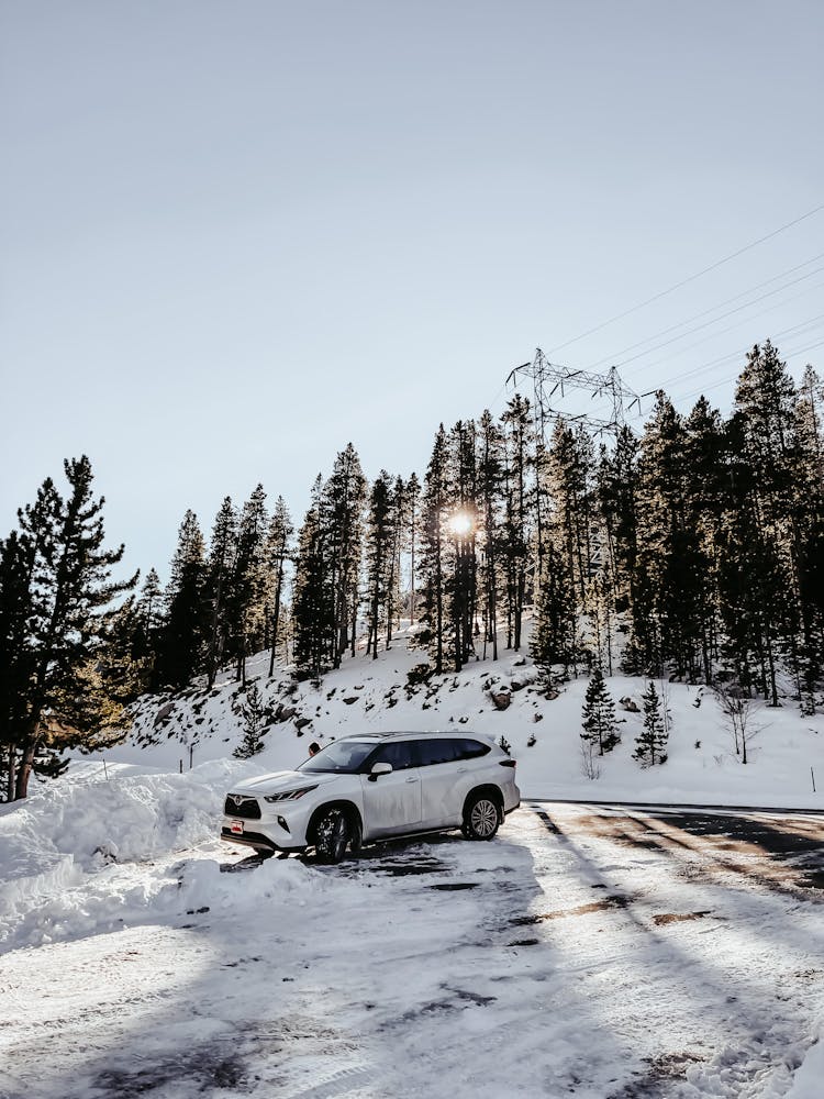 White Suv On Road Covered With Snow