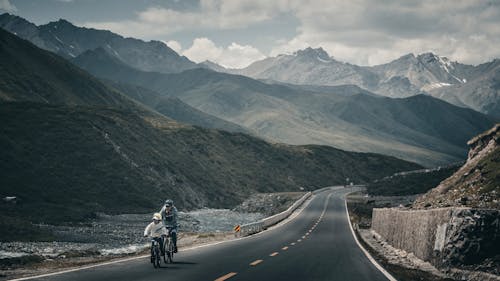 Free Two People Riding a Bicycle on the Highway Stock Photo