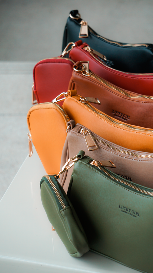 Free A stylish collection of colorful leather coin purses displayed on a white surface. Stock Photo