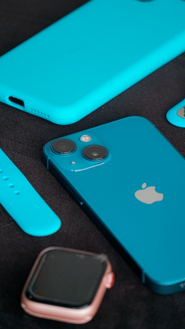 Close-up of a blue smartphone and accessories arranged on a black surface, showcasing modern technology. - mobile accessories Pakistan