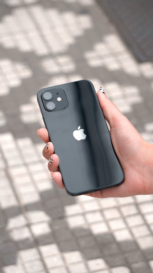 Free A Person Holding a Black Mobile Phone Stock Photo