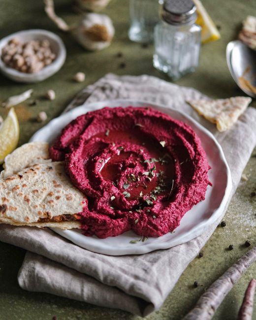 Vibrant beetroot hummus served with flatbread, perfect for a healthy snack.