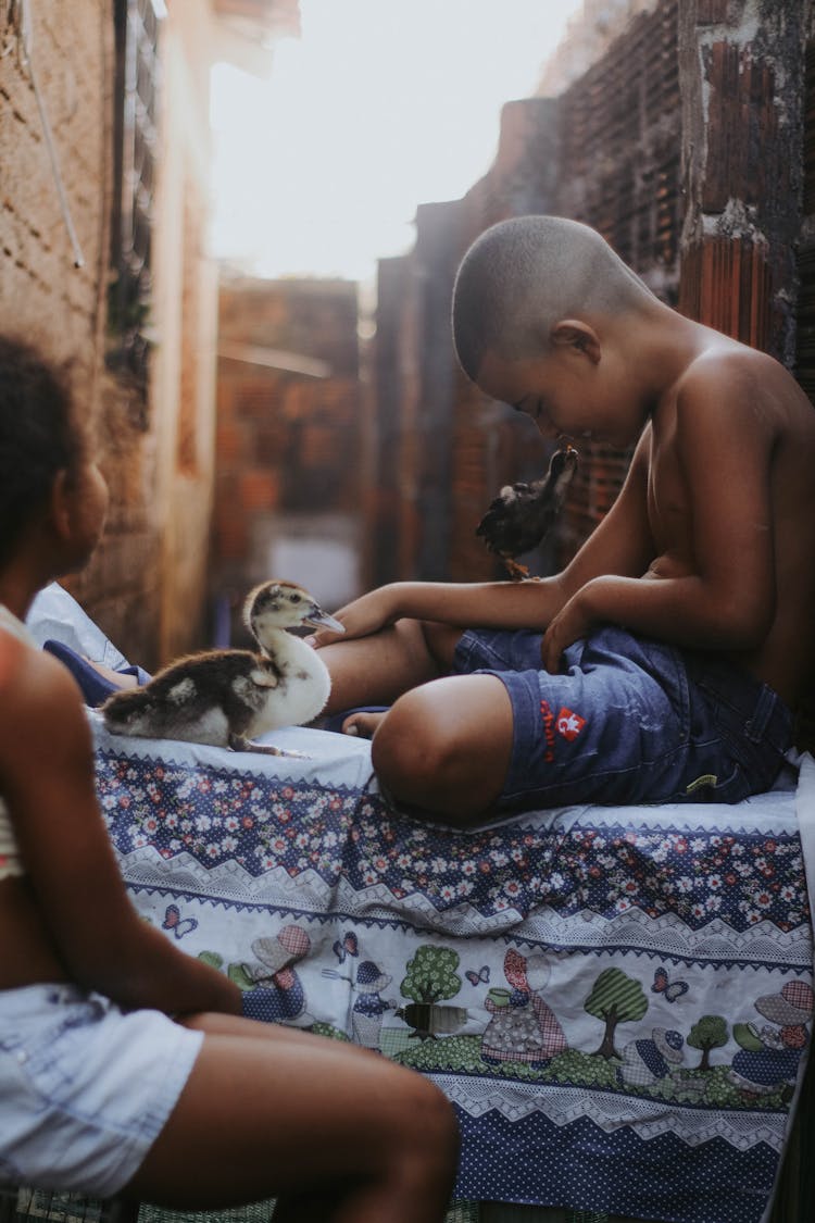 Shirtless Young Boy Sitting On The Table