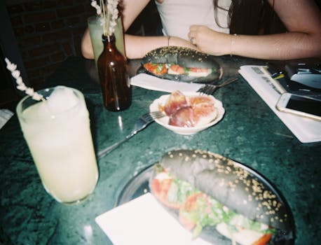 Delectable sandwiches and drinks at a cozy restaurant setting, perfect for a casual meal.