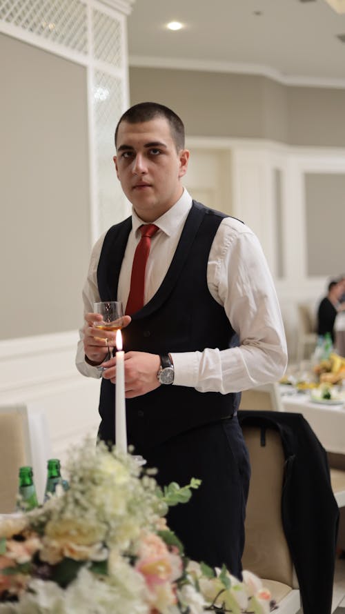 Free A Man in White Long Sleeves with Black Vest Holding a Wine Glass Stock Photo