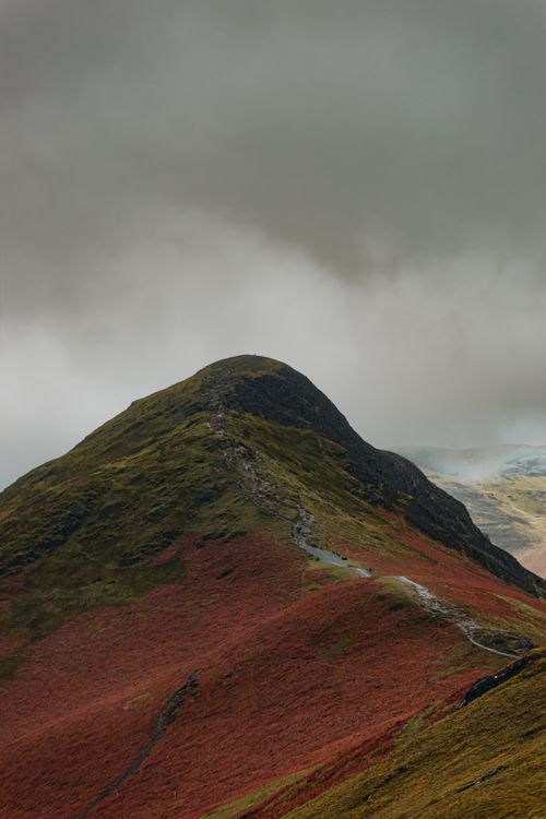 Free Majestic hill landscape under a moody, overcast sky, showcasing vibrant earth tones. Stock Photo