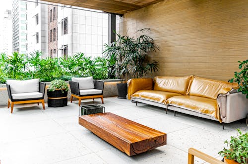 Photo of a Stylish indoor patio featuring modern furniture and lush greenery.