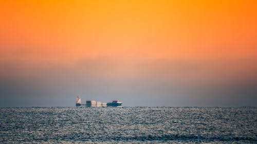 White and Red Cargo Ship on Sea