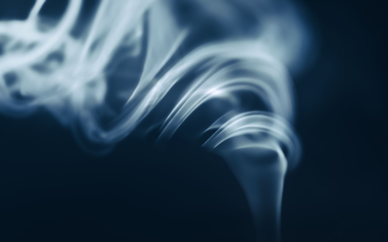 artistic abstract blue smoke swirl captured on a dark background perfe