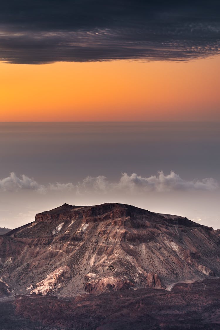 A Volcano Under Golden Sky