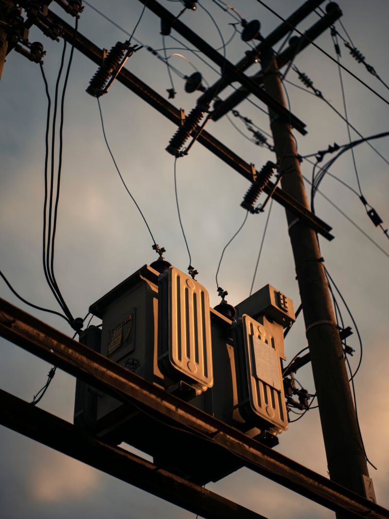 Transformer on transmission tower at sunset