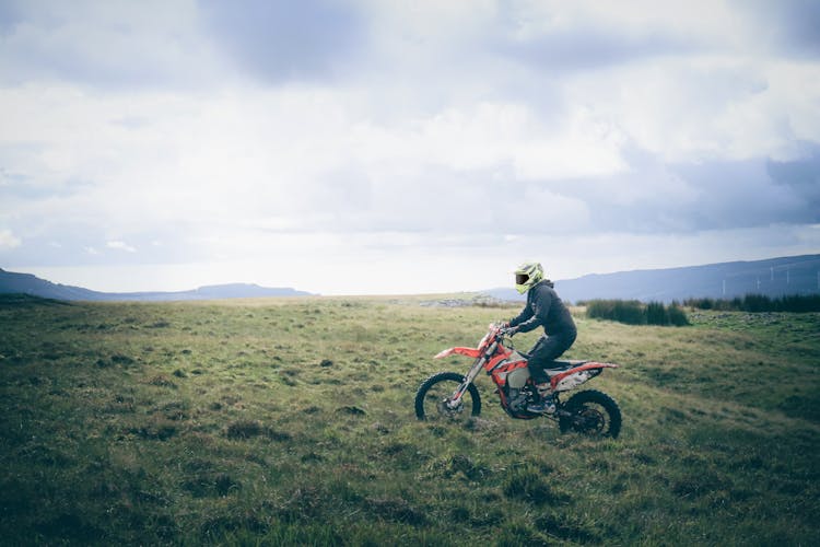 A Man Riding A Motocross On The Grass