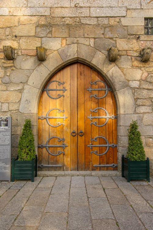 Free A Wooden Door Near the Stone Wall Stock Photo