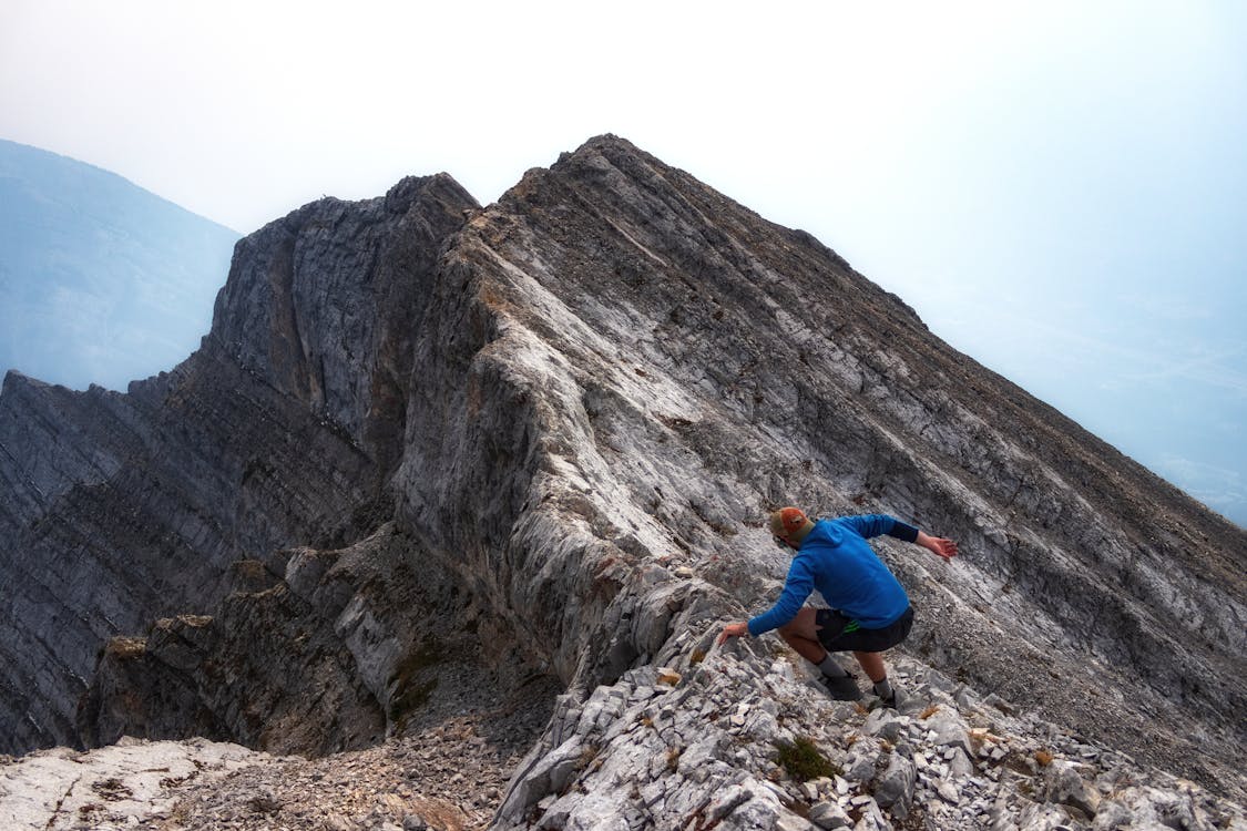 A Man Standing on the Rock Mountain