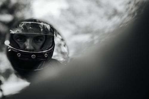 Free A Man in Black Helmet Looking at the Mirror Stock Photo