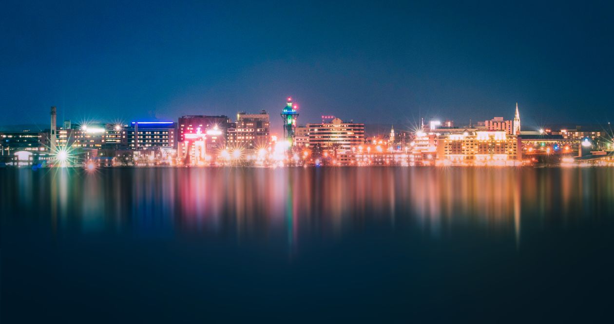 A City Skyline Near the Ocean at Night · Free Stock Photo
