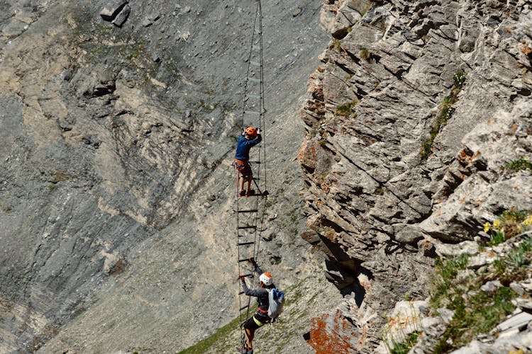 Rock Climbers Ascending On Ladder