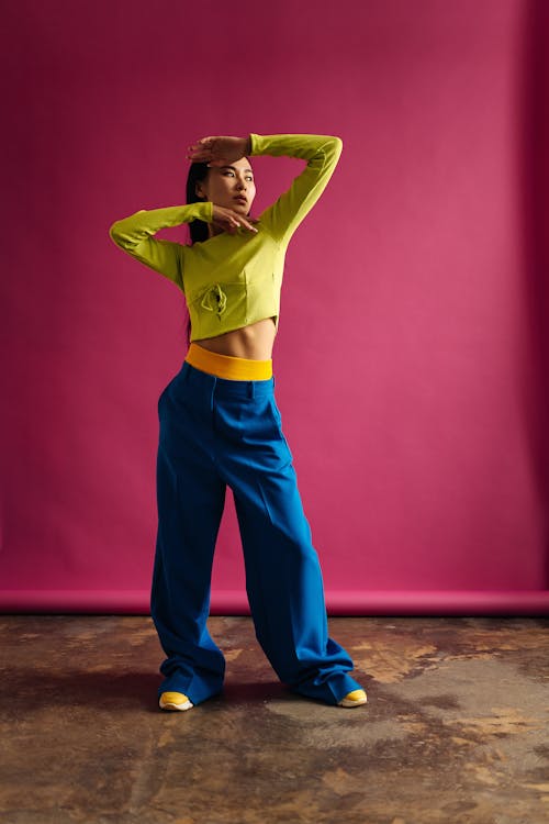 A Woman in Blue Pants with Her Hands on Her Face