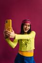 Woman in Colorful Outfit Taking Selfie