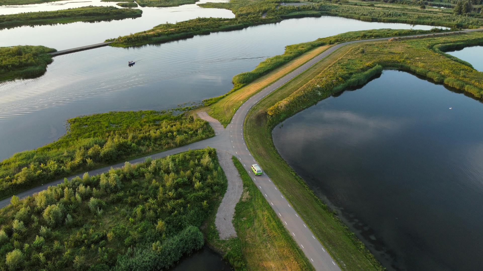 A scenic aerial view of lush green fields and waterways in the Netherlands.