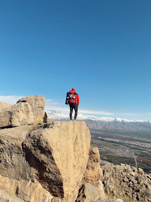 Free A Hiker on the Edge of a Cliff Stock Photo